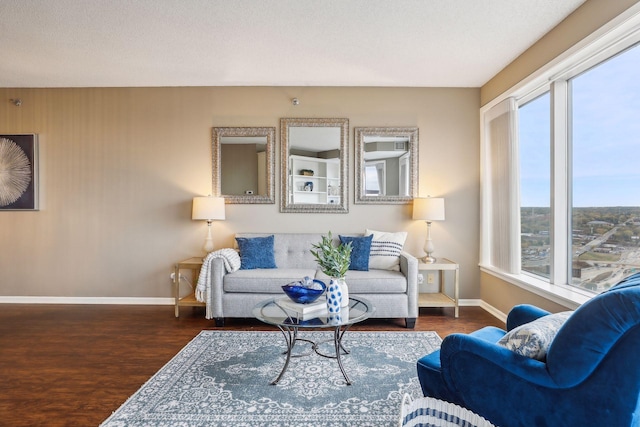 living room featuring a textured ceiling, plenty of natural light, and dark hardwood / wood-style flooring