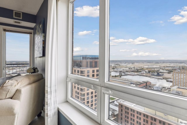 sunroom / solarium featuring a water view