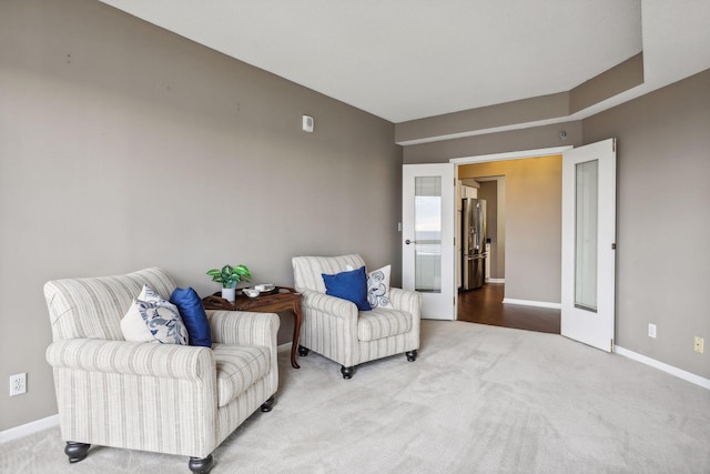 sitting room featuring carpet flooring