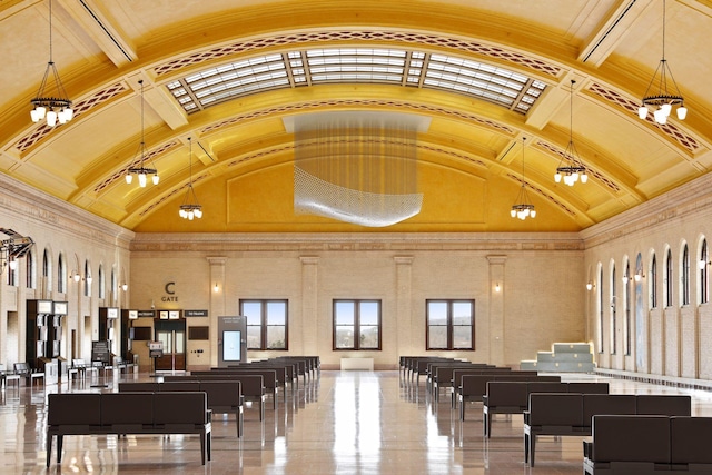 misc room featuring a notable chandelier, high vaulted ceiling, and ornamental molding