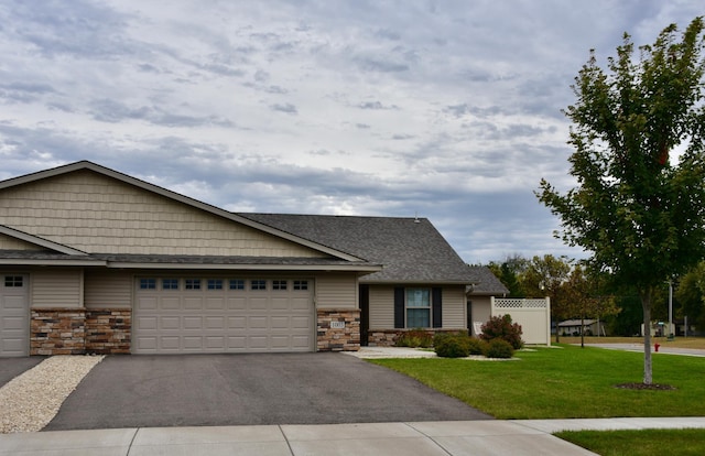 view of front of house with a front yard and a garage