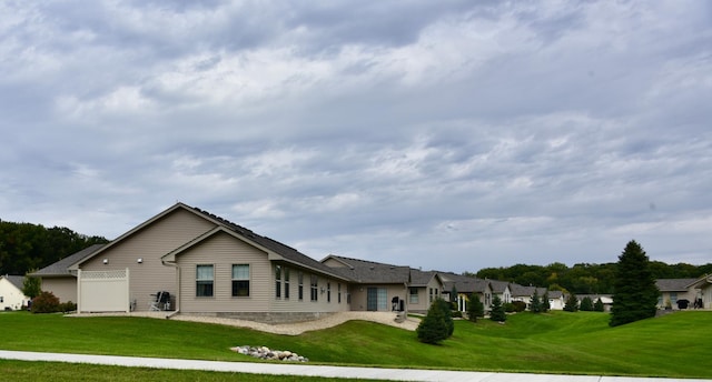 back of property with a lawn