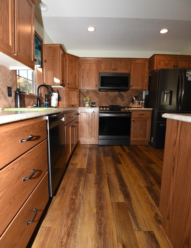 kitchen with stainless steel appliances, tasteful backsplash, and dark hardwood / wood-style flooring