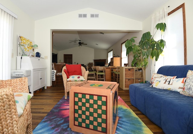 living room featuring ceiling fan, dark hardwood / wood-style floors, vaulted ceiling, and a wealth of natural light