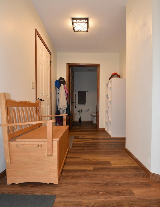 hallway with dark hardwood / wood-style flooring