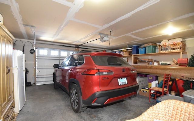 garage featuring a garage door opener and white fridge