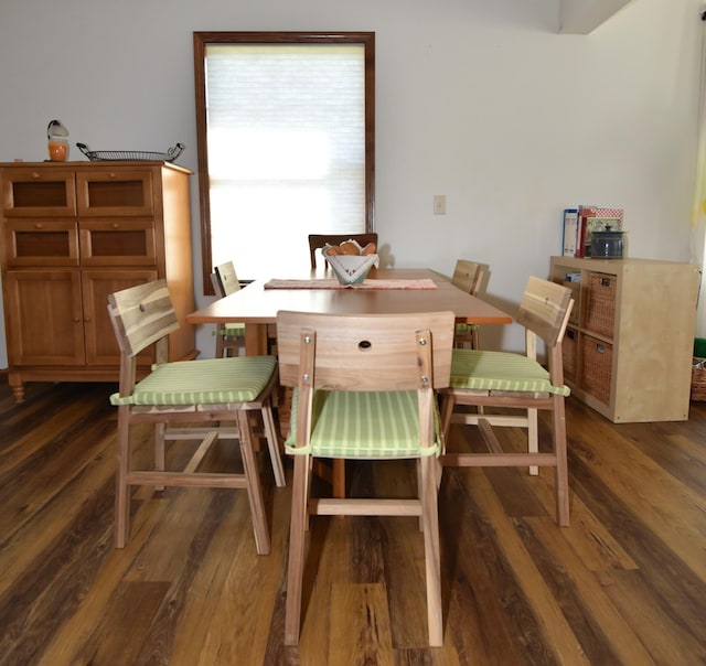 dining area featuring dark wood-type flooring