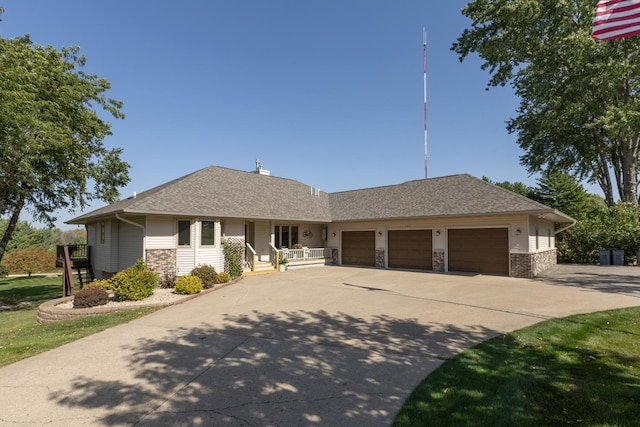 view of front of property featuring covered porch and a garage