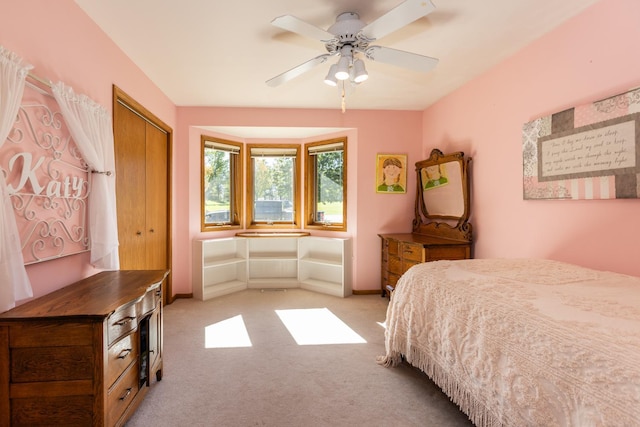 carpeted bedroom featuring a closet and ceiling fan