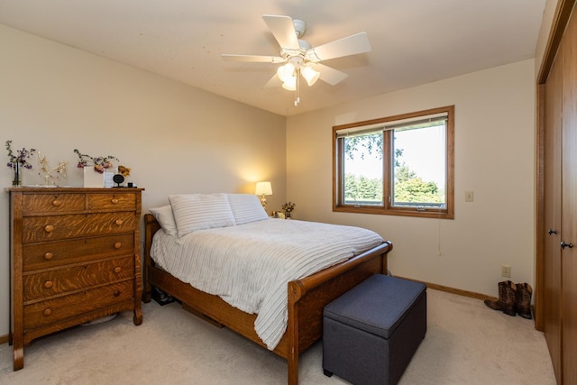 carpeted bedroom with ceiling fan and a closet