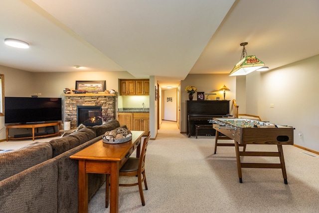 carpeted living room featuring a fireplace