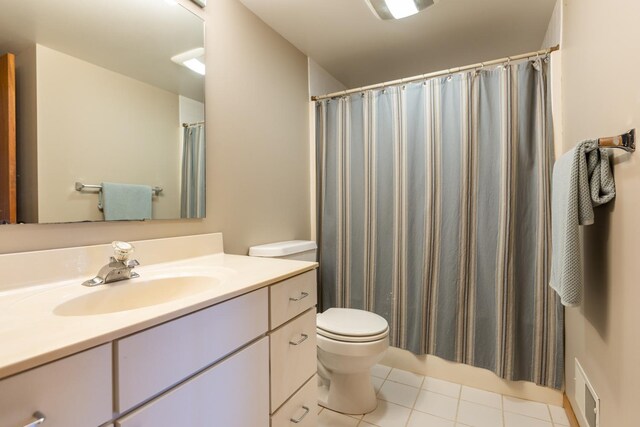 bathroom featuring tile patterned floors, curtained shower, vanity, and toilet