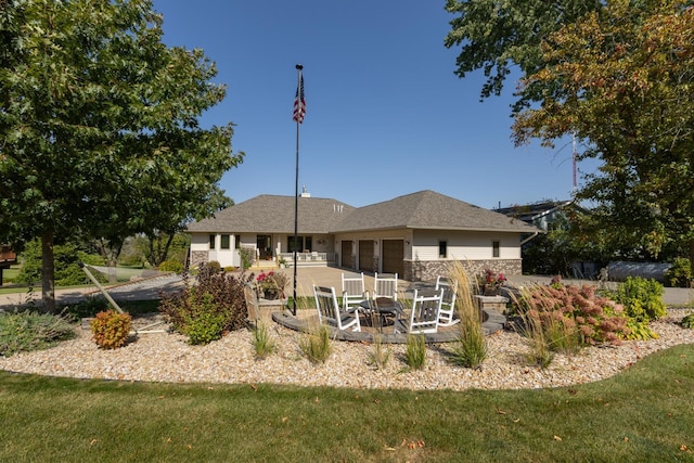 back of property featuring a lawn and a patio