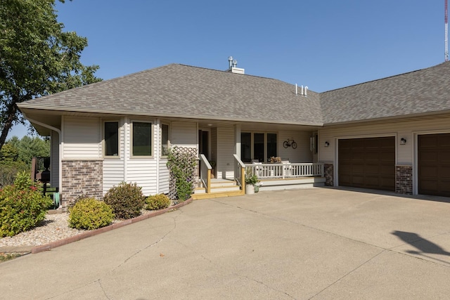 single story home with a porch and a garage