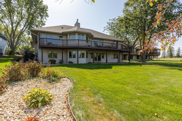 back of house featuring a deck and a yard