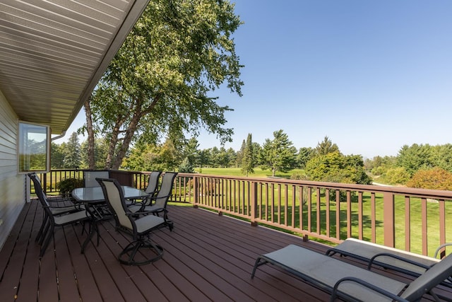 wooden terrace with a lawn