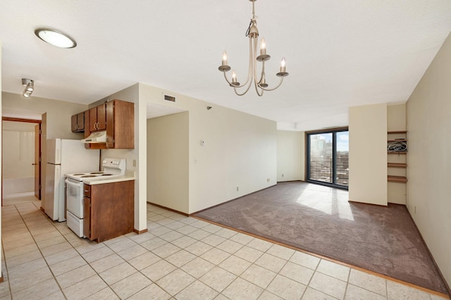 kitchen with light carpet, an inviting chandelier, hanging light fixtures, and white appliances