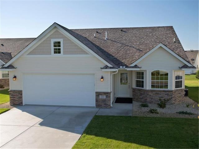 view of front of house with a front yard and a garage