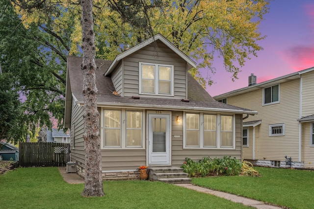 bungalow-style house featuring a yard