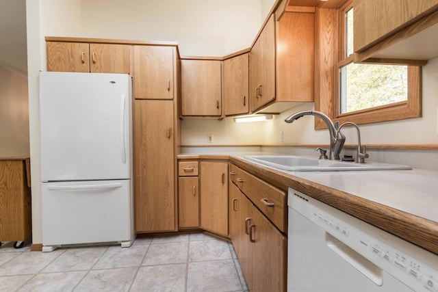 kitchen featuring white appliances, light tile patterned flooring, and sink