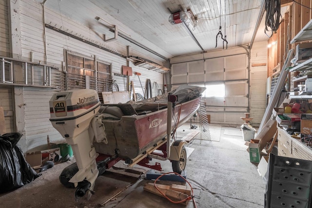 garage with wood walls and a garage door opener