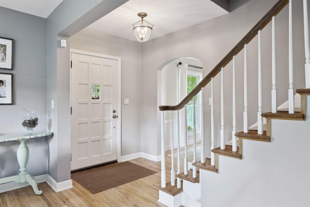 entrance foyer featuring a notable chandelier and light hardwood / wood-style floors