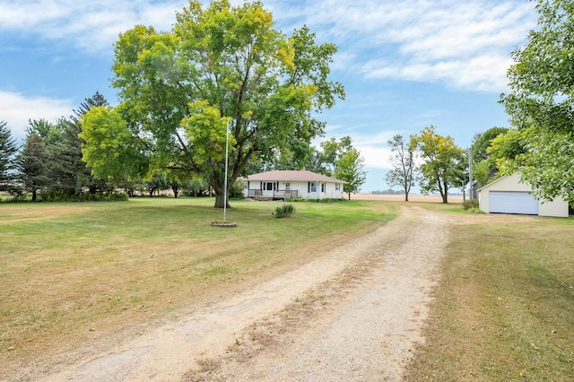 view of yard featuring a garage and an outbuilding