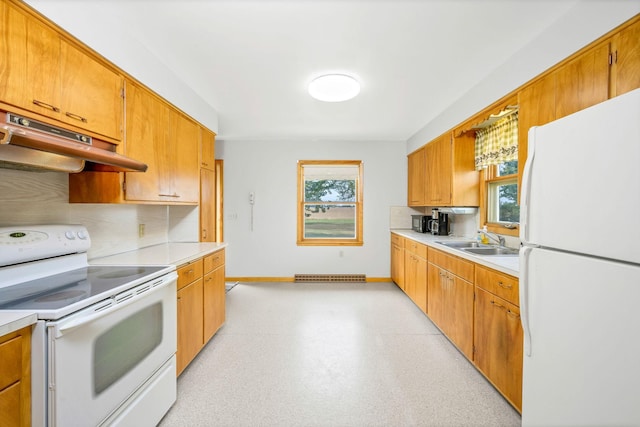 kitchen with decorative backsplash, white appliances, plenty of natural light, and sink