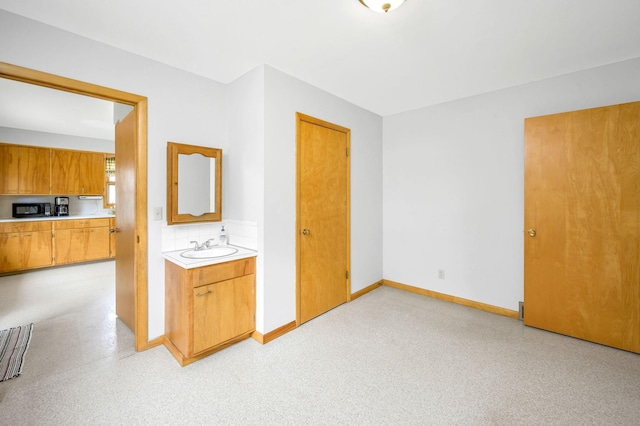 unfurnished bedroom with sink and ensuite bath