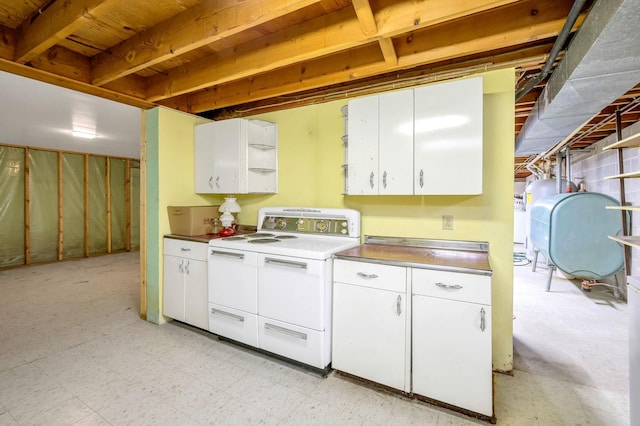 kitchen featuring white cabinetry and white range oven