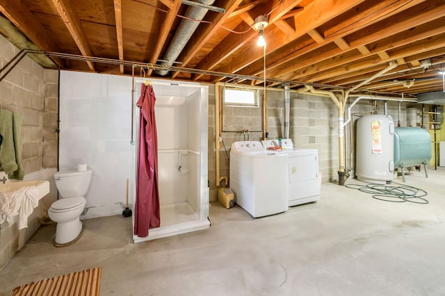 basement featuring water heater and separate washer and dryer