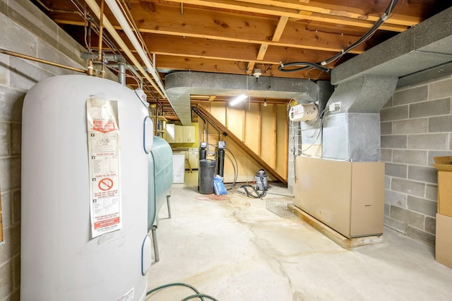 basement featuring water heater and heating unit