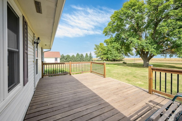 wooden terrace with a lawn