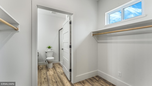 bathroom featuring hardwood / wood-style floors and toilet