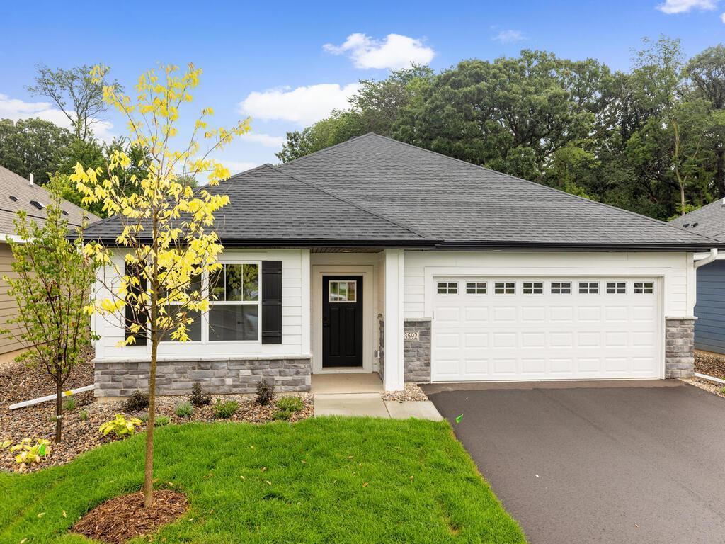 19400 Everglade Path, Farmington, MN 55024 - single story home with aphalt driveway, roof with shingles, stone siding, a garage, and a front lawn