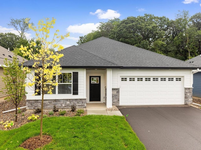 19400 Everglade Path, Farmington, MN 55024 - single story home with aphalt driveway, roof with shingles, stone siding, a garage, and a front lawn