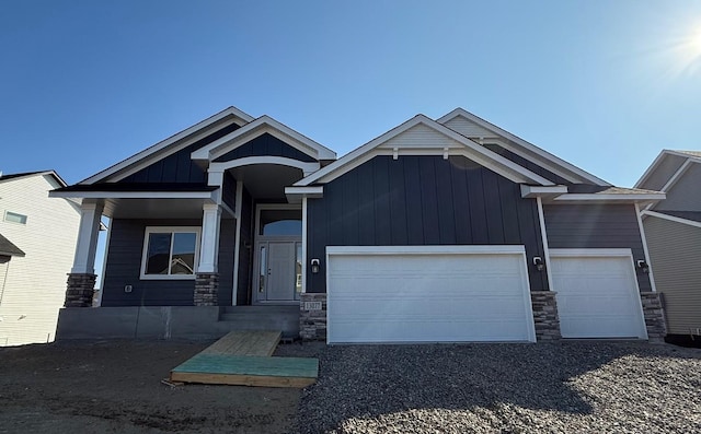 13077 Opal St NE, Blaine, MN 55449 - craftsman-style house featuring stone siding, board and batten siding, and an attached garage