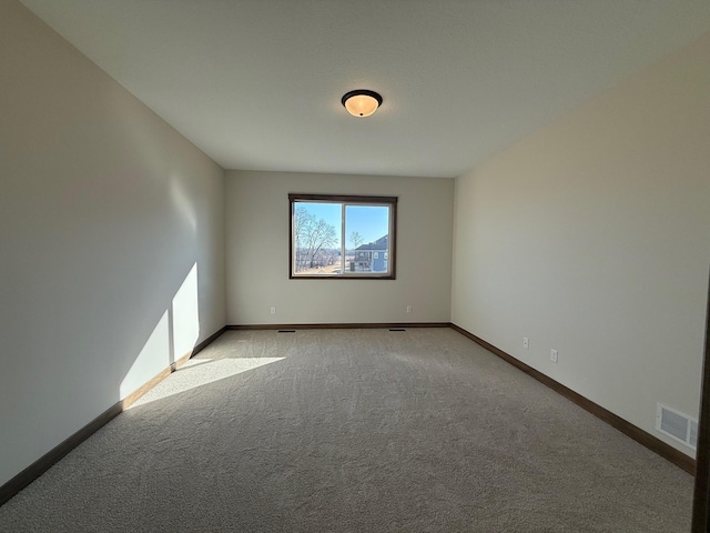 13077 Opal St NE, Blaine, MN 55449 - spare room with visible vents, baseboards, and light colored carpet