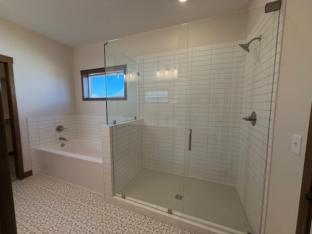 13077 Opal St NE, Blaine, MN 55449 - bathroom with a bath, a shower stall, and tile patterned floors