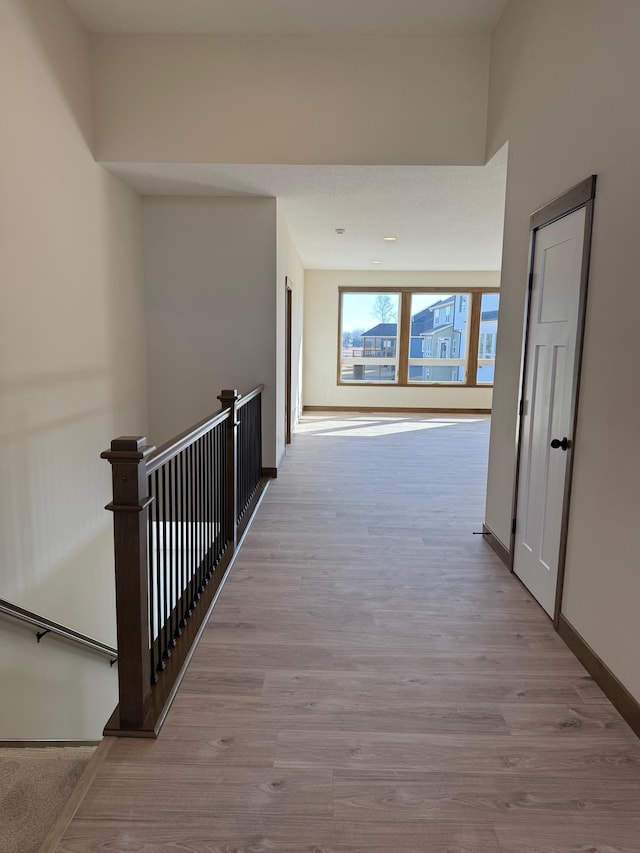 13077 Opal St NE, Blaine, MN 55449 - corridor featuring an upstairs landing, baseboards, and wood finished floors