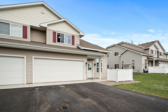 view of front facade featuring a front lawn and a garage