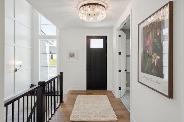 foyer with a notable chandelier and light hardwood / wood-style floors