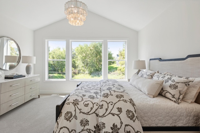 bedroom with light carpet, lofted ceiling, and a notable chandelier