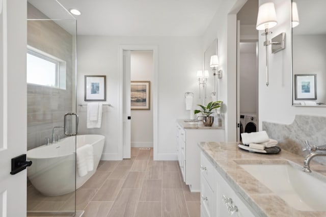 bathroom featuring independent shower and bath and vanity