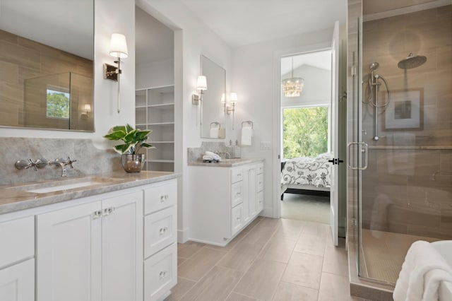 bathroom with backsplash, an enclosed shower, vaulted ceiling, and vanity