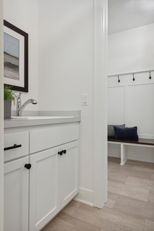 bathroom featuring vanity, hardwood / wood-style floors, and a textured ceiling