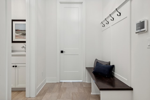 mudroom featuring light wood-type flooring and sink