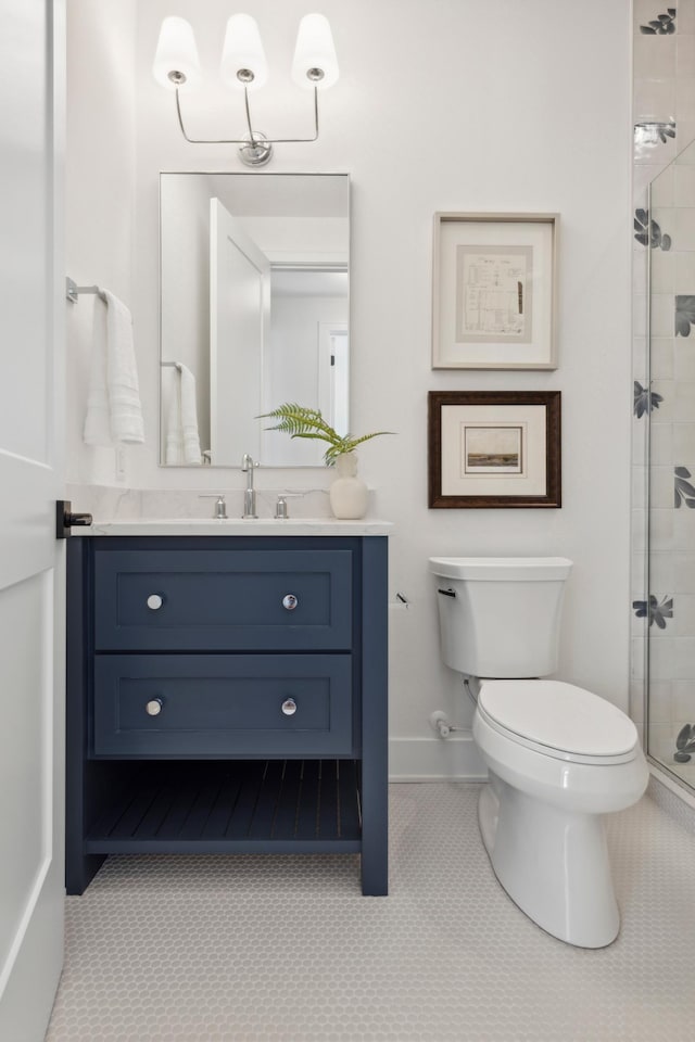 bathroom featuring vanity, tile patterned flooring, toilet, and an enclosed shower