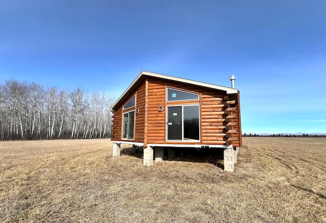 view of property exterior featuring log exterior