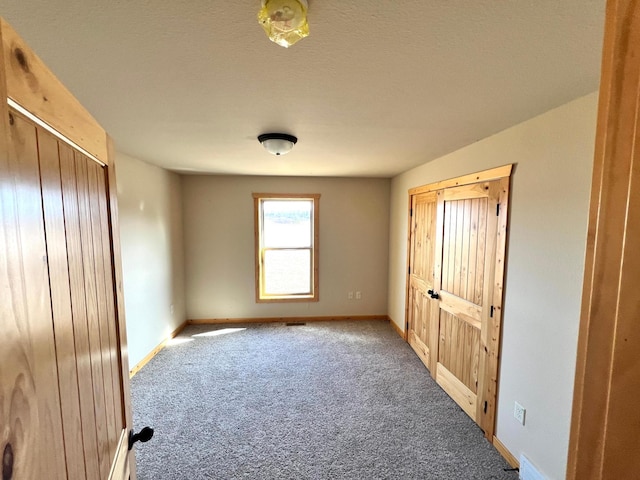 unfurnished bedroom with baseboards and carpet flooring